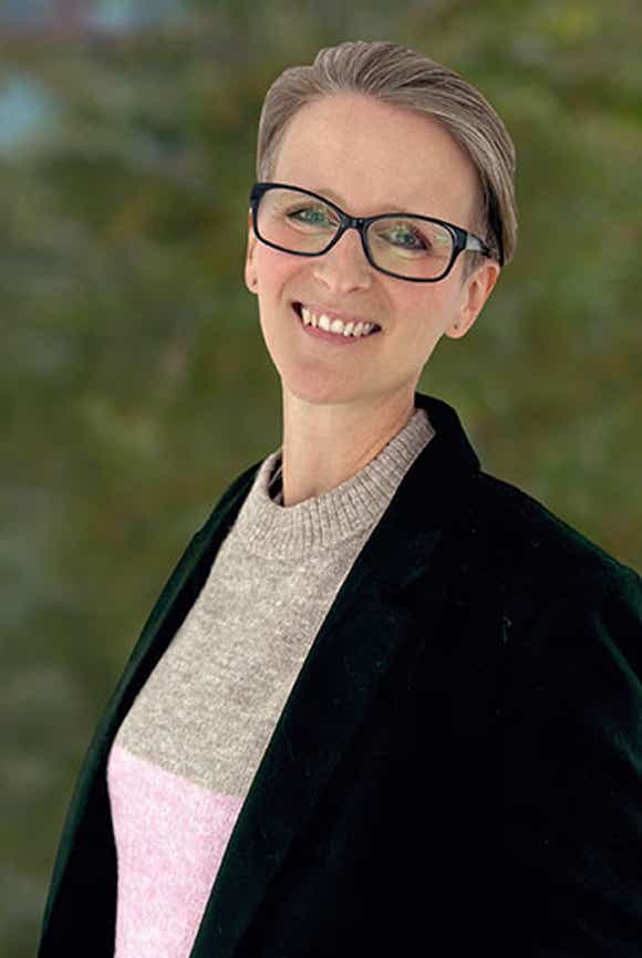 large image of richardson's chief product officer kate lewis against a forested background
