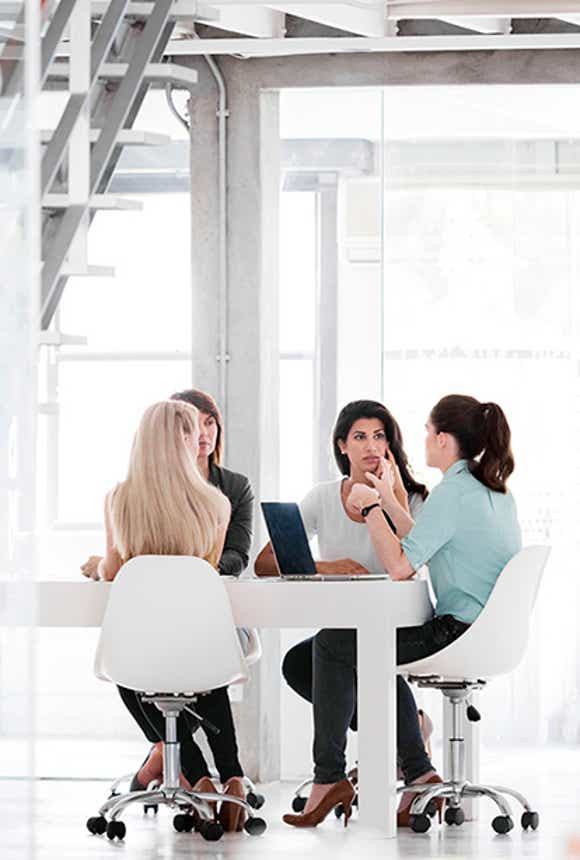 sales leader talking to her team in a conference room exercising agile sales management capabilities