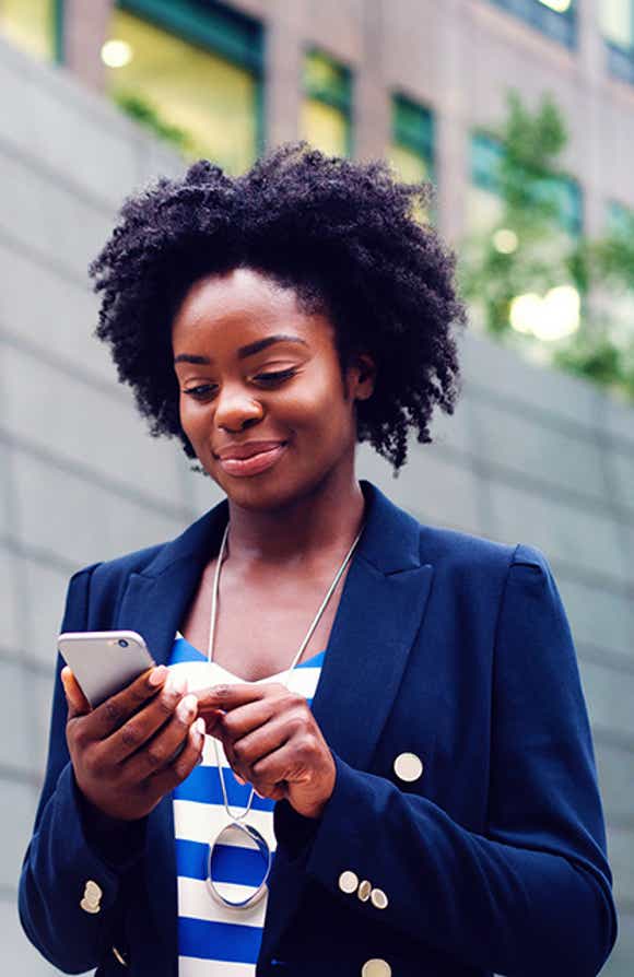 young stylish african american sales person completing her prospecting activities on her phone because she has the ability to prospect with agility after completing richardson's prospecting training program