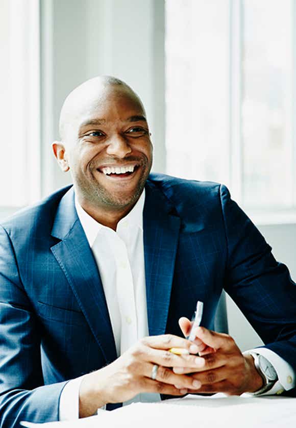 stylish african american salesman engaging a buyer off camera using solution messaging skills